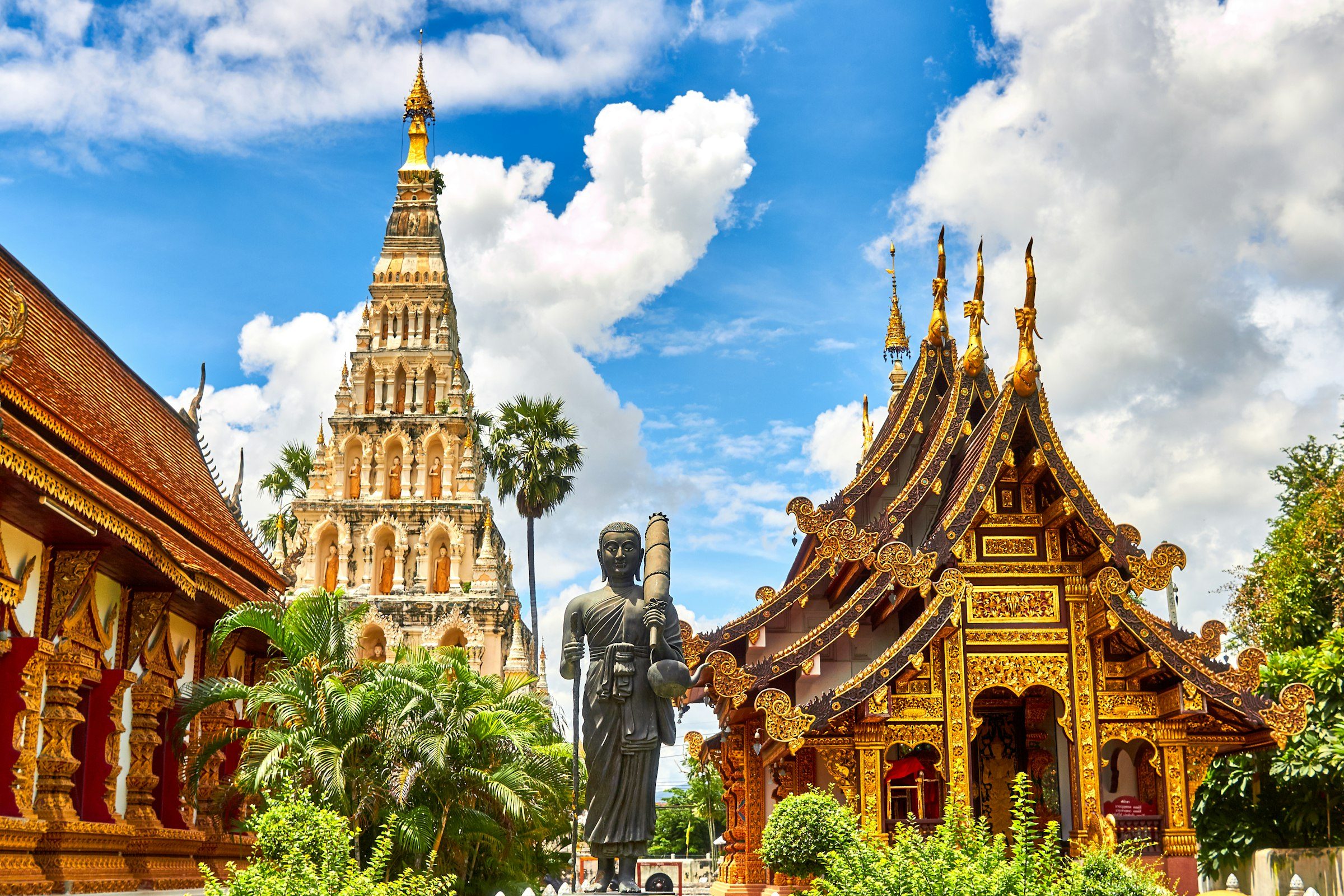 Asia-Oceania cultural heritage — golden temple spires and ceremonial figures